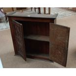 A 19th century carved oak cupboard with twin doors enclosing one fixed shelf, height 80cm, width