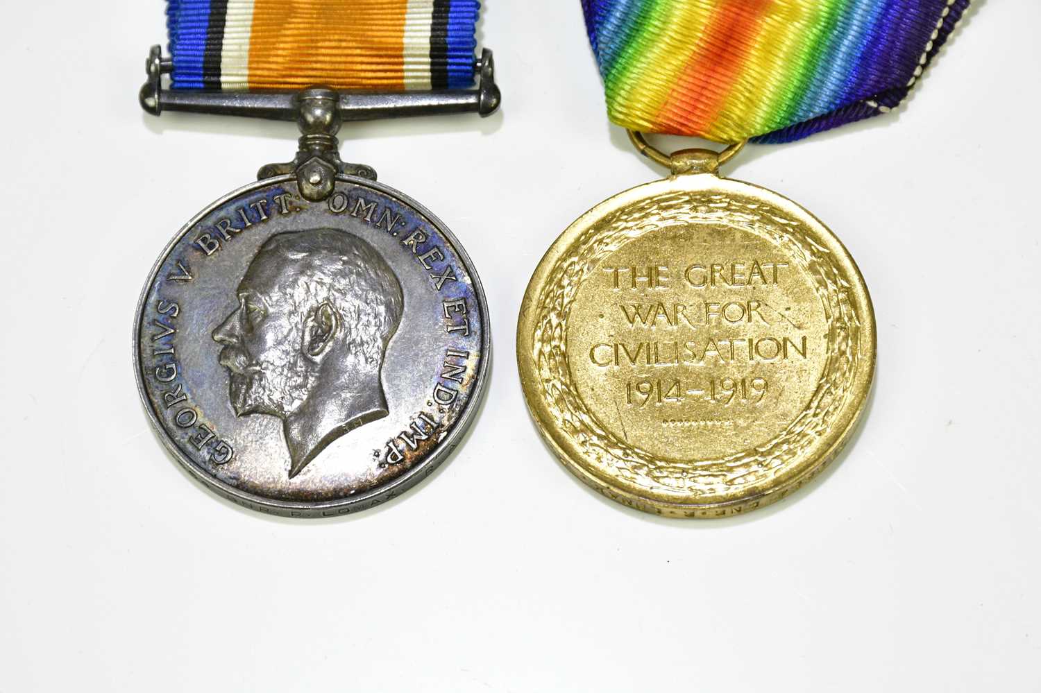A WWI medal pair comprising War and Victory Medals named to GNR Lomax R.A., in a Dill's tobacco - Image 3 of 13