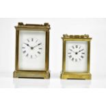 Two brass cased carriage clocks, both with white enamel dials and set with Roman numerals, larger