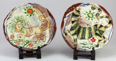 † BEN FOSKER (born 1960); a pair of slip decorated earthenware plates depicting a lion and a