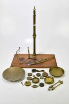 A set of Victorian brass balance scales with assorted weights.