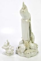 An early 20th century German blanc-de-chine model of a cockerel perching on a column above five