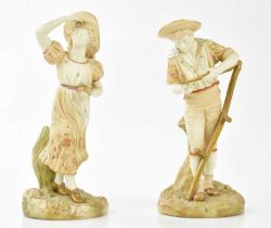 ROYAL WORCESTER; a pair of blush ivory figures representing a farmhand holding a scythe and a girl