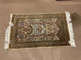 A silk beige ground Hereke rug, 138cm x 83cm.