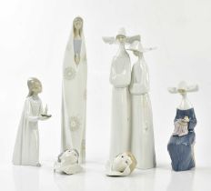 LLADRO; four figures including two nuns walking, height 32cm with two wall plaques modelled as