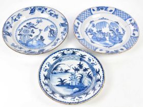 Three 19th century Delft blue and white chargers, diameter 34cm, 34cm, and 30cm (all af) (3).