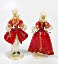 MURANO; a pair of decorative figures wearing cloaks, in shades of red, gilt and white, height 22cm.
