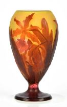 ATTRIBUTED TO GALLÉ; a cameo glass pedestal vase, decorated with irises, bears pseudo signature,