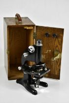BECK, LONDON; a lacquered microscope in oak case.