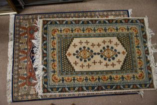 An Eastern style rug decorated with stylised motifs on a blue, cream and red ground, length approx