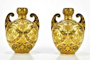 ROYAL CROWN DERBY; a pair of Egyptian Revival twin handled vases, height 16cm. Condition Report: