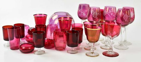 A collection of Victorian style cranberry coloured glassware to include various sized glasses, a
