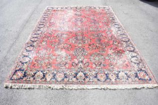 A large Eastern style carpet with floral sprays on a predominantly blue ground, length 348cm., width