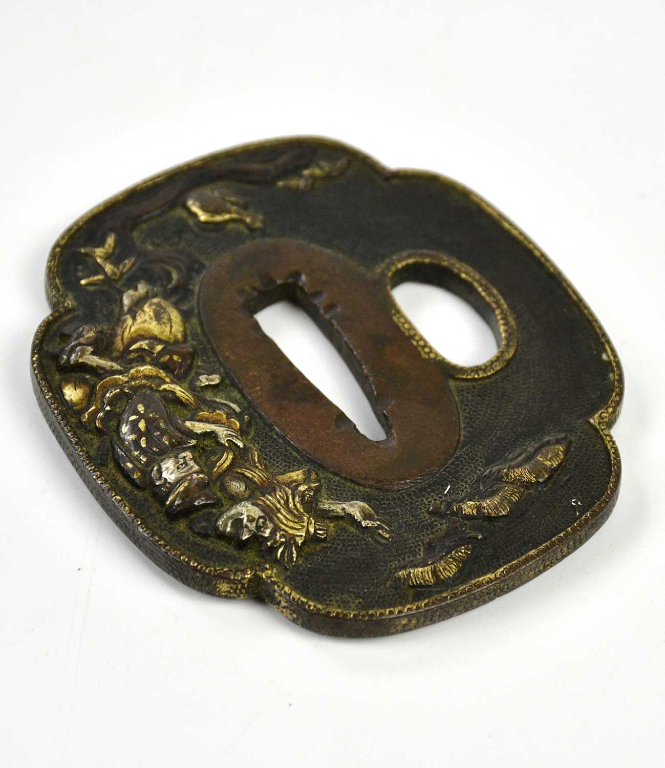 A Japanese bronze tsuba with gilt highlights, approx 7 x 6cm.