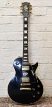 GIBSON; a Les Paul custom, in black with gold hardware, serial number 00118077, sold with hard case.