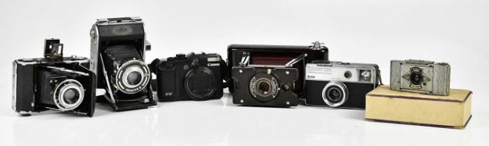 A small groups of camera to include a Kodak Instamatic 333-X, a Canon power shot G12, a Zeiss