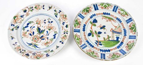 Two 18th century Delft polychrome chargers, possibly Bristol, diameters 33.5cm and 34.5cm (2)