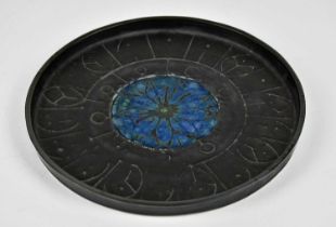 TROIKA POTTERY; a circular wall charger with impressed stylised decoration and a blue glazed centre,
