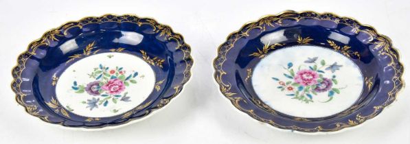 DR WALL; a pair of 18th century Worcester plates with scalloped edges, decorated to the centre