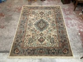 A large rug with stylised landscape and floral decoration on a predominantly brown ground, approx