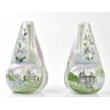 A pair of Arts & Crafts style vases, each decorated with classical buildings and floral sprays,