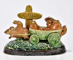 GEORGE TINWORTH FOR DOULTON LAMBETH; a 'Going to the Derby' figure group, modelled with frogs in a
