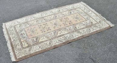 An Eastern style rug of geometric decoration, 123cm x 226cm