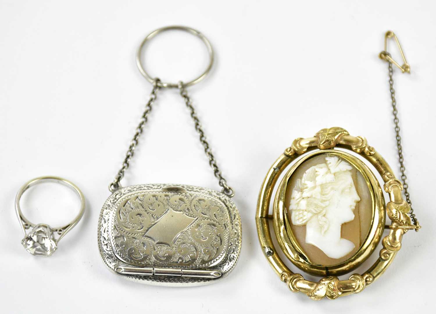 A late Victorian cameo brooch in pinchbeck frame, an unusual silver pillbox from a chatelaine, and a