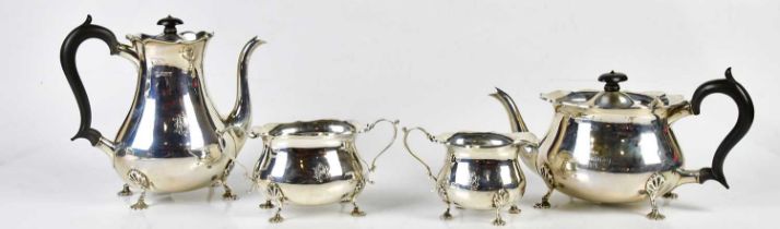 MARTIN, HALL & CO LTD; a George V hallmarked silver four piece tea service with cast scalloped edge,