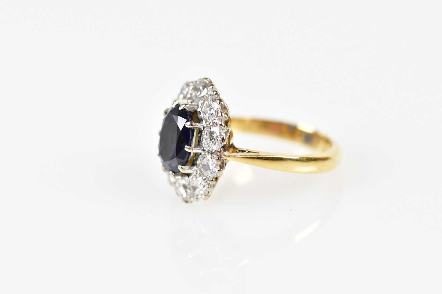 An 18ct yellow gold sapphire and diamond oval cluster ring, the claw set raised sapphire within a - Image 2 of 5