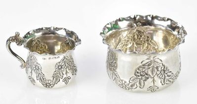 WILLIAM DEVENPORT; a Victorian hallmarked silver cream jug and sugar bowl, with chased floral