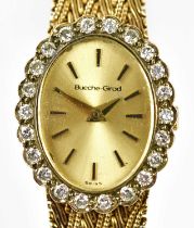 BEUCHE-GIROD; a lady's 9ct yellow gold wristwatch with diamond set bezel, oval dial, and integral