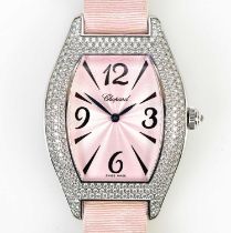 CHOPARD; an 18ct white gold pink dial and diamond smothered lady's wristwatch with tonneau shaped