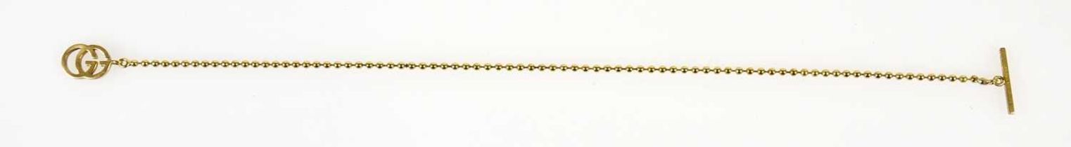 GUCCI; a fine 18ct gold small bead bracelet with GG to one end and bar closure, stamped 750,