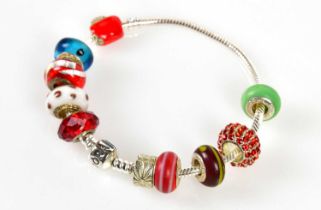 PANDORA; a sterling silver chain bracelet, with five glass beads and silver charms, and five other