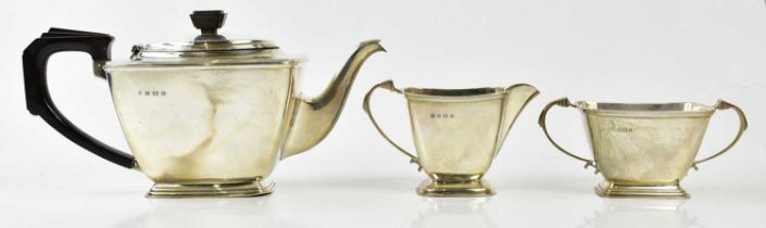 WILLIAM NEALE; a George V hallmarked silver three piece tea service in the Art Deco style,