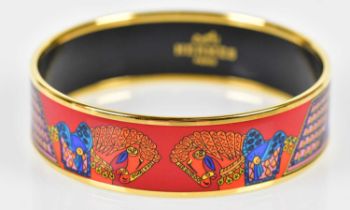 HERMÈS; an enamel painted bangle with gold plated trim, signed and further inscribed 'Made in