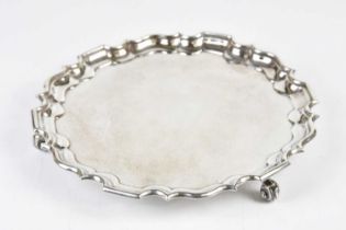 THOMAS BRADBURY & SONS; a George V hallmarked silver salver with cast scalloped edge on scrolling