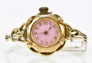 An unusual hinged bangle set with a 14ct yellow gold crown wind watch with Arabic numerals to the