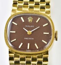 ROLEX; a lady's 14ct yellow gold wristwatch with oval dark red dial set with baton markers, with