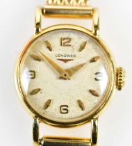 LONGINES; a lady's vintage 14ct yellow gold wristwatch with baton markers and Arabic numerals to the