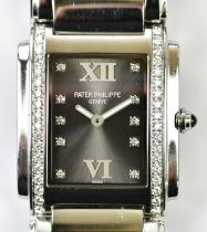 PATEK PHILIPPE; a stainless steel and diamond set ref: 4910 lady's wristwatch with diamond hour