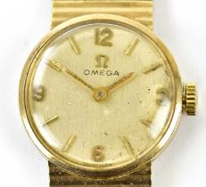 OMEGA; a 9ct yellow gold lady's vintage wristwatch with circular dial and integral bracelet,