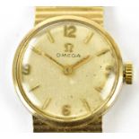 OMEGA; a 9ct yellow gold lady's vintage wristwatch with circular dial and integral bracelet,