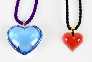 BACCARAT; a blue crystal heart shaped pendant, and a smaller Lalique red example, both boxed (2)