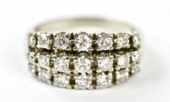 A white metal diamond three row cluster ring set with twenty-one round brilliant cut graduated