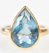 An 18ct yellow gold and aquamarine ring, the pear shaped stone with pierced gallery measuring approx