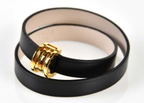 BULGARI; a black double loop leather bracelet, with gold tone closure embossed with maker's logo,