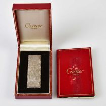 CARTIER; a textured finish lighter numbered 145238 and with Cartier booklet, in original box.