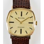 BULOVA; a gentleman's vintage yellow metal cased wristwatch with shaped dial set with baton